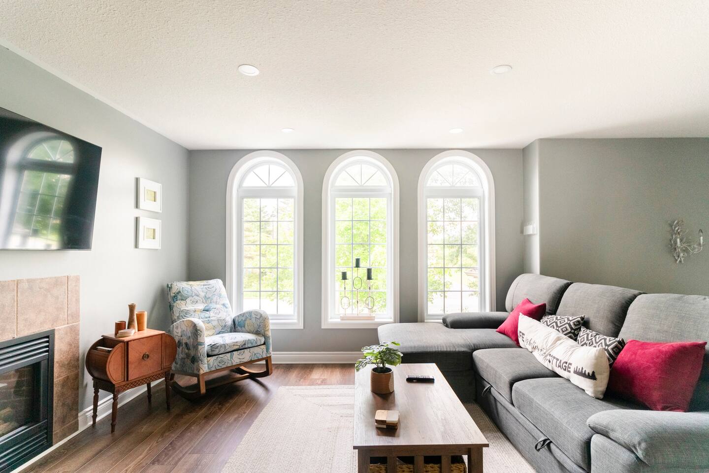 Bright living room with arched windows and a fireplace